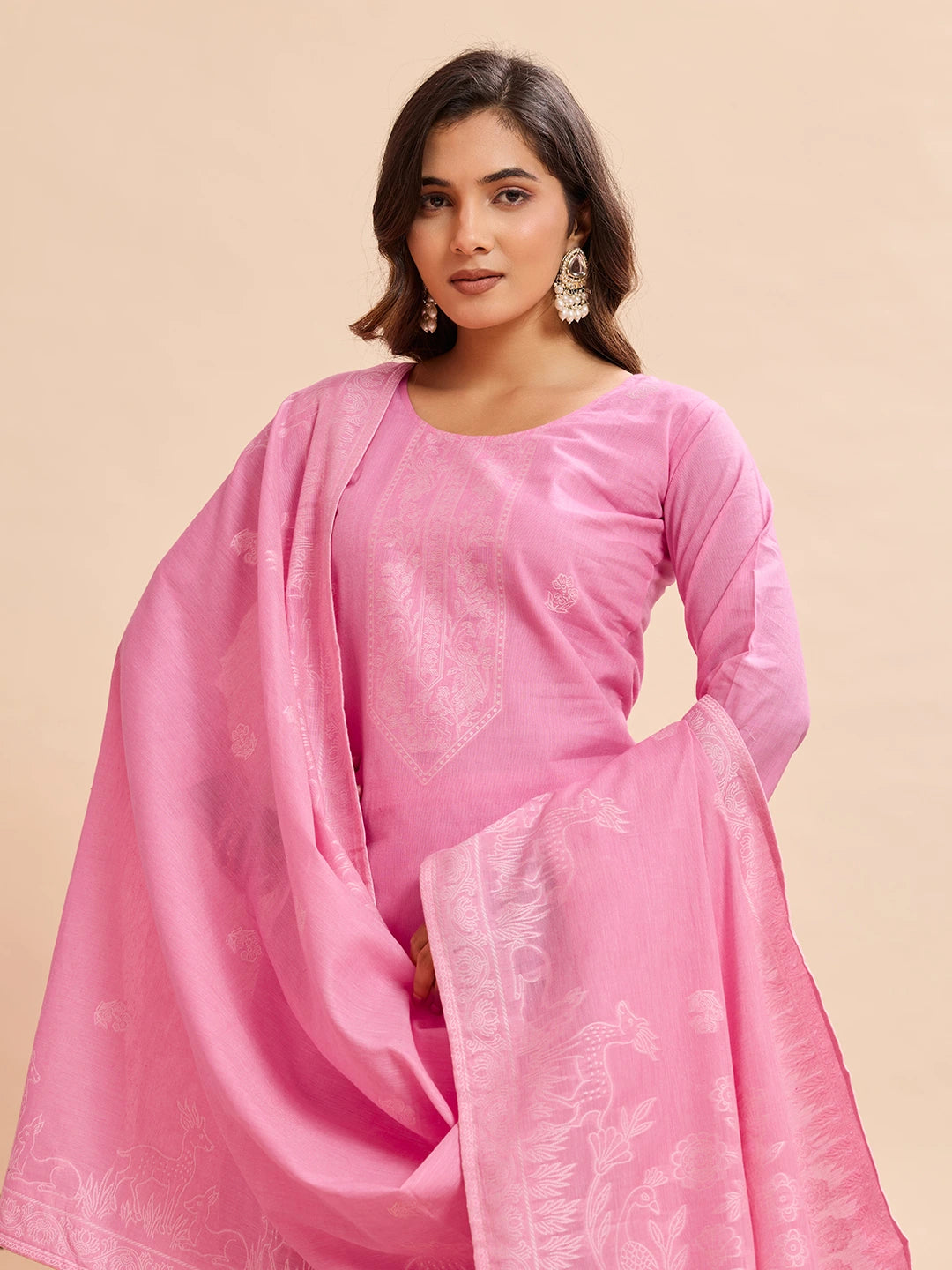 Woman wearing a pink traditional outfit with a beige background